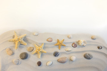 Stars and stones on the sand with copy space
