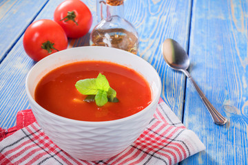 Tomato soup on wooden table.