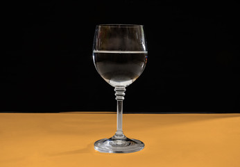 glass on a wooden table. Front view.