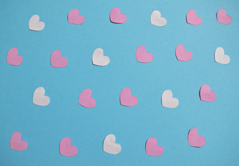 white,pink, red hearts on a blue background. Valentine's day hearts pattern. Valentines day card with white color hearts