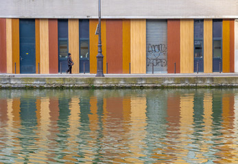 Paris, France - 12 29 2019: Ourcq Canal. Reflection of a building on the water