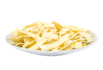 Italian pasta in a white plate isolated on a white background. Pasta with durum wheat.