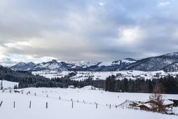 Fototapeta na wymiar snow-covered winter landscape with a trail in the ski area reit im winkl