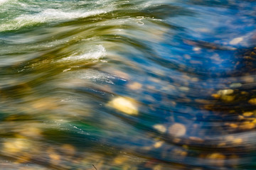 Smooth river flow in a transparent water river.