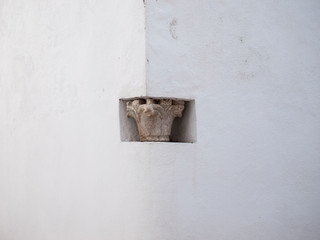 Roman column capital on street corner in Cordoba in Spain