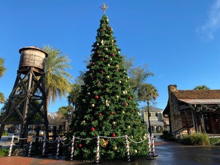 water tower farm cabin tall large towering holiday christmas tree decorated ornaments stage outside outdoors blue sky