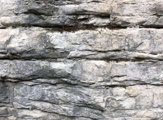 The Grey stone wall of the old mountain. Grey texture of natural stone, abstract background. 