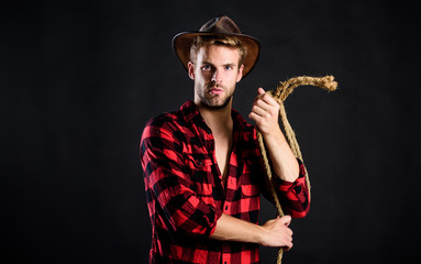 is he bandit. western cowboy portrait. man checkered shirt on ranch. Vintage style man. Wild West retro cowboy. cowboy with lasso rope. Western. wild west rodeo. man in hat black background