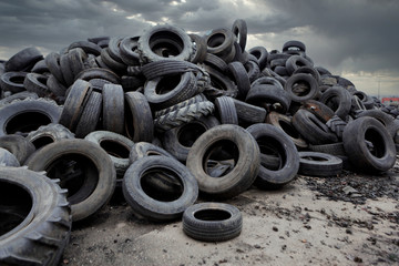 Industrial landfill for the processing of waste tires and rubber tyres. Pile of old tires and...