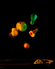 dice and chips on a black background illuminated by a small beam of light