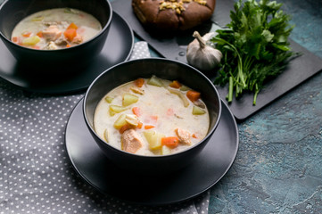 Close up Finnish traditional salmon soup with cream. Kalakeitto. Fish soup with potatoes and carrots.