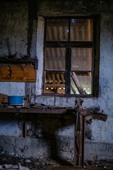 old abandoned house interior with broken furniture and empty windows