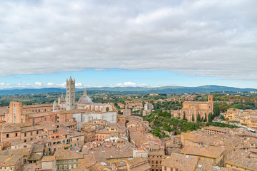 Fototapeta na wymiar Beautiful aerial panoramic view of Old Town of medieval city of Siena in the cloudy autumn day, Tuscany, Italy