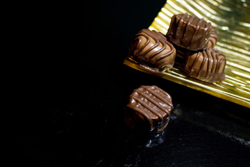 Various of sweet confectionery with chocolate candies and pralines. Handmade chocolates. Realistic chocolate set, delicious dessert pattern.