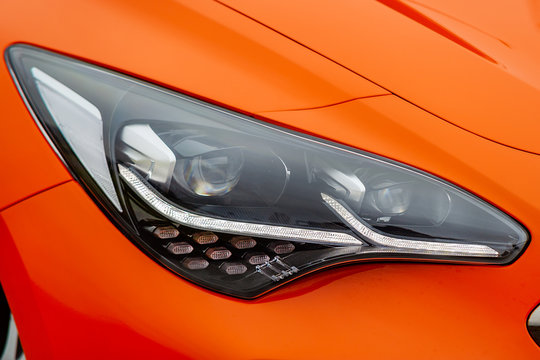 Front light of orange car © yakub88