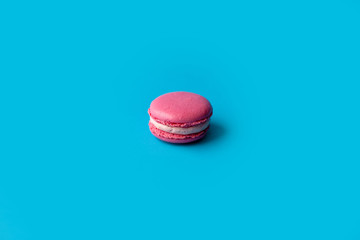 Colorful macaroons on blue background.