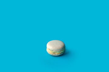 Colorful macaroons on blue background.