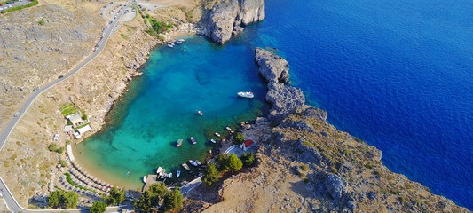Aerial drone top down ultra wide photo of paradise bay of Saint Paul next to iconic castle and village of Lindos, Rodos island, Dodecanese, Greece