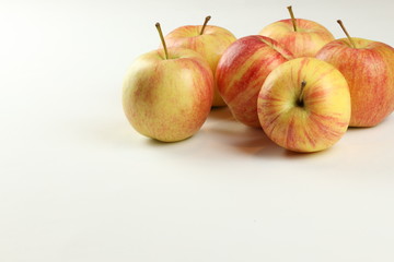 red-yellow ripe apples on a white background with place for text