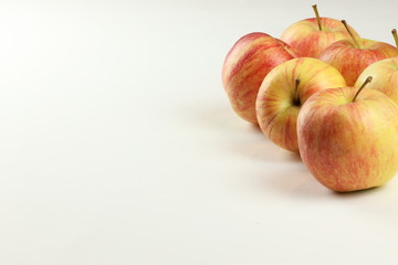 red-yellow ripe apples on a white background with place for text