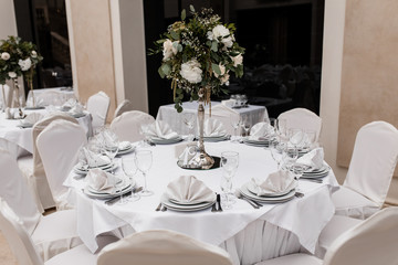 Served white round table with a floral centerpiece at the restaurant