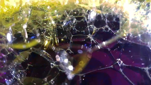 Video footage of beautiful colorful bubbles and lights fantasy magic  effect, abstract background with multi-color light rays with shining sparkling soap foam close up