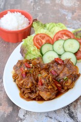 Ayam Kecap. Chicken cooked or stew in thick sweet soy sauce and spices. Served with rice, lettuce, sliced cucumber and tomato