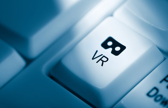 Computer keyboard with Blue toned key with virtual reality glasses button with text and icon, for connecting a vr device to the internet