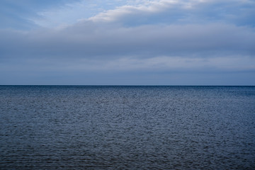 empty sea beach in autumn with some bushes and dry grass