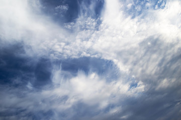 Obraz premium White curly clouds in a blue sky. Sky background