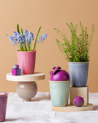 Modern still life with flowers, bright fruits and mugs on a white tablecloth. Greeting card.