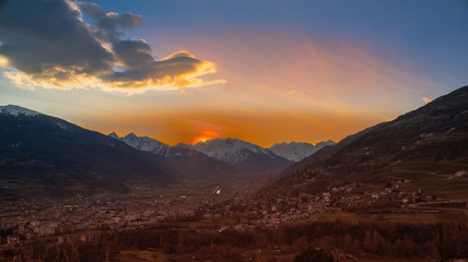Naklejka na ściany i meble Mountain Panorama on sunset, blue and orange sky on italian alps