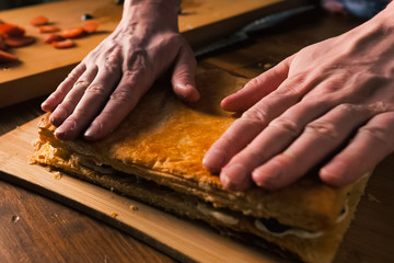 Folding layers of puff pastry pie with filling.