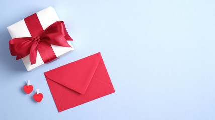 Valentines day background with gift box, red hearts and envelope. Flat lay, top view, copy space. St Valentines Day, love, romance concept.