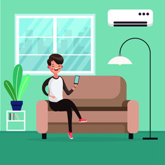 A person controls the air conditioner by phone and relaxes on the couch