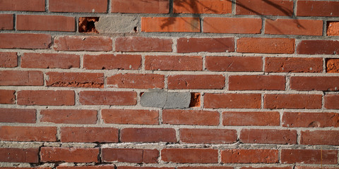 Old red weathered brick wall horizontal grunge background