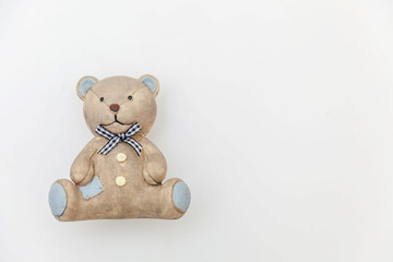 Simply minimal design with toy bear isolated on white background. Children care materinity family concept. Flat lay, top view, copy space