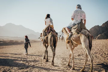 Fotobehang a ride on the camel © Valeriysurujiu