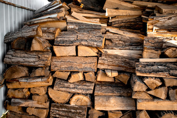 Pile of firewood. Harvesting firewood for the winter. Heating season, eco-raw materials. Selective focus