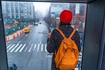 girl woman with backpack watching the streets of new york city brooklyn