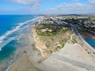 Aerial view of Del Mar North Beach, California coastal cliffs and House with blue Pacific ocean....