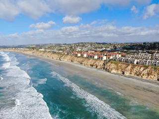 Aerial view of Del Mar North Beach, California coastal cliffs and House with blue Pacific ocean....