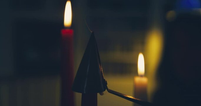 Candles being extinguished by a snuffer