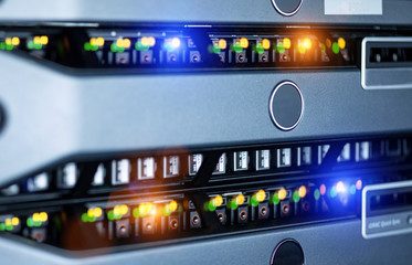 Server units in cloud service data center showing flickering light indicators for massive data...