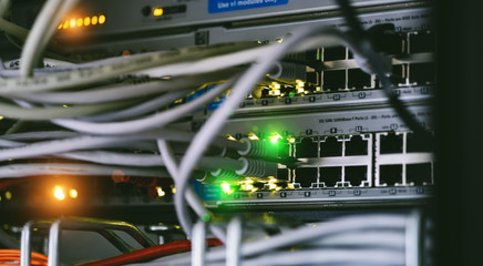 Server units in cloud service data center showing flickering light indicators for massive data connection bandwidth, close up shot.