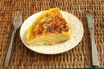 Piece od Spanish omelet on a mat for snack