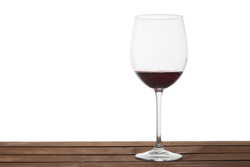 Glass of red wine on a table with isolated background