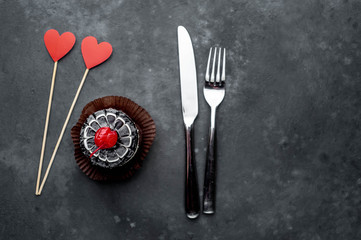 cherry cheesecake with carved hearts from  red paper on a stone background with copy space for your text. Breakfast concept for a loved one on Valentine's Day