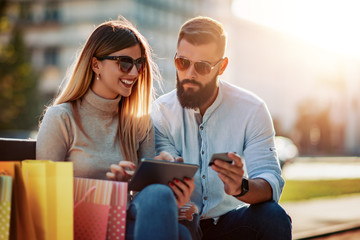 Happy young couple using a digital tablet together