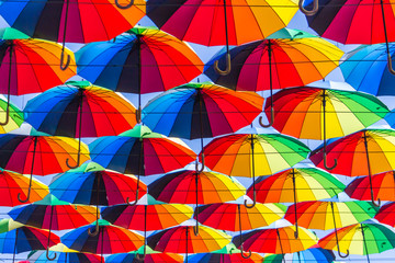 Fototapeta na wymiar Colorful bright umbrella street decoration over sky